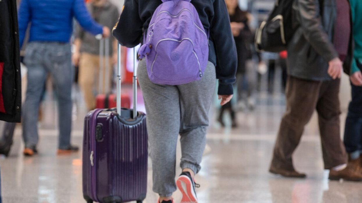 A traveller walking through the terminal at Toronto Pearson International Airport (YYZ).
