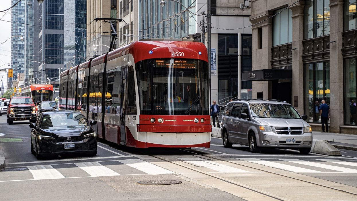A TTC streetcar and cars in traffic on King Street in Toronto.