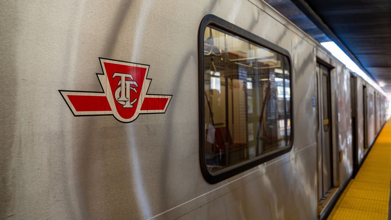 A TTC subway car stopped at a station platform.