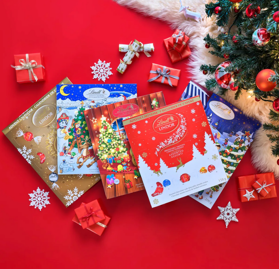 A variety of Lindt advent calendars on a red background.