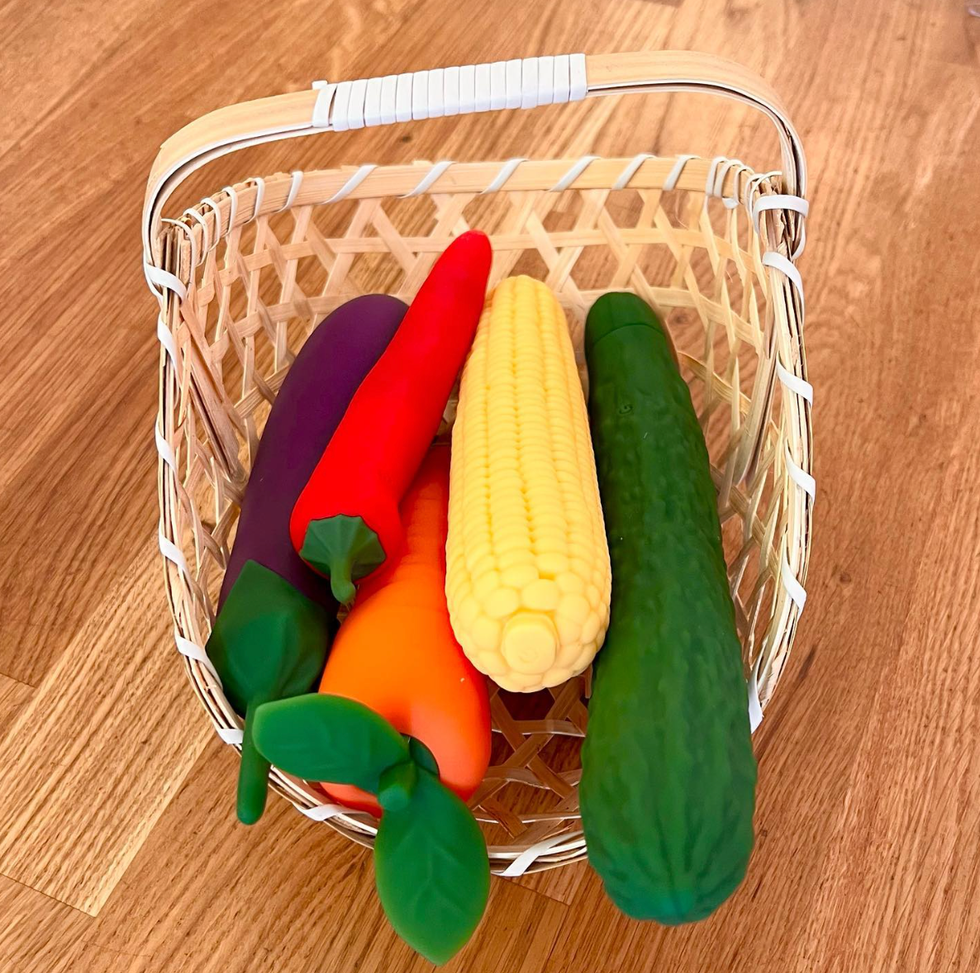 A variety of vegetable-shaped sex toys in a basket.