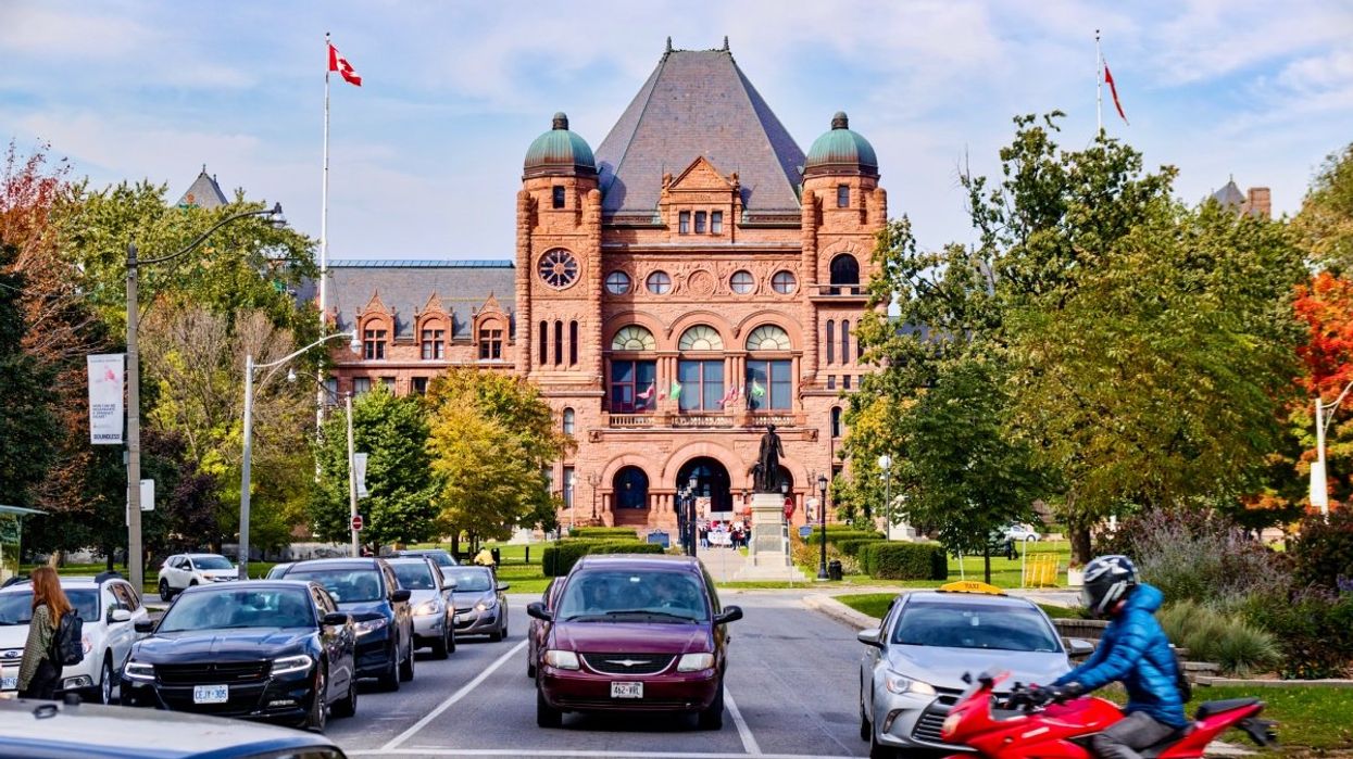 A view of cars driving down University Road in Toronto.