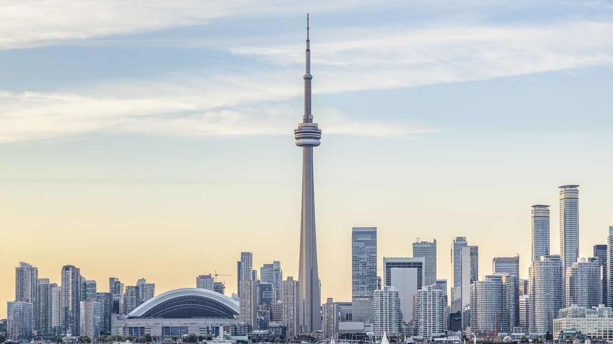 A view of Downtown Toronto skyline with the CN Tower, Rogers Centre and financial district at sunset.