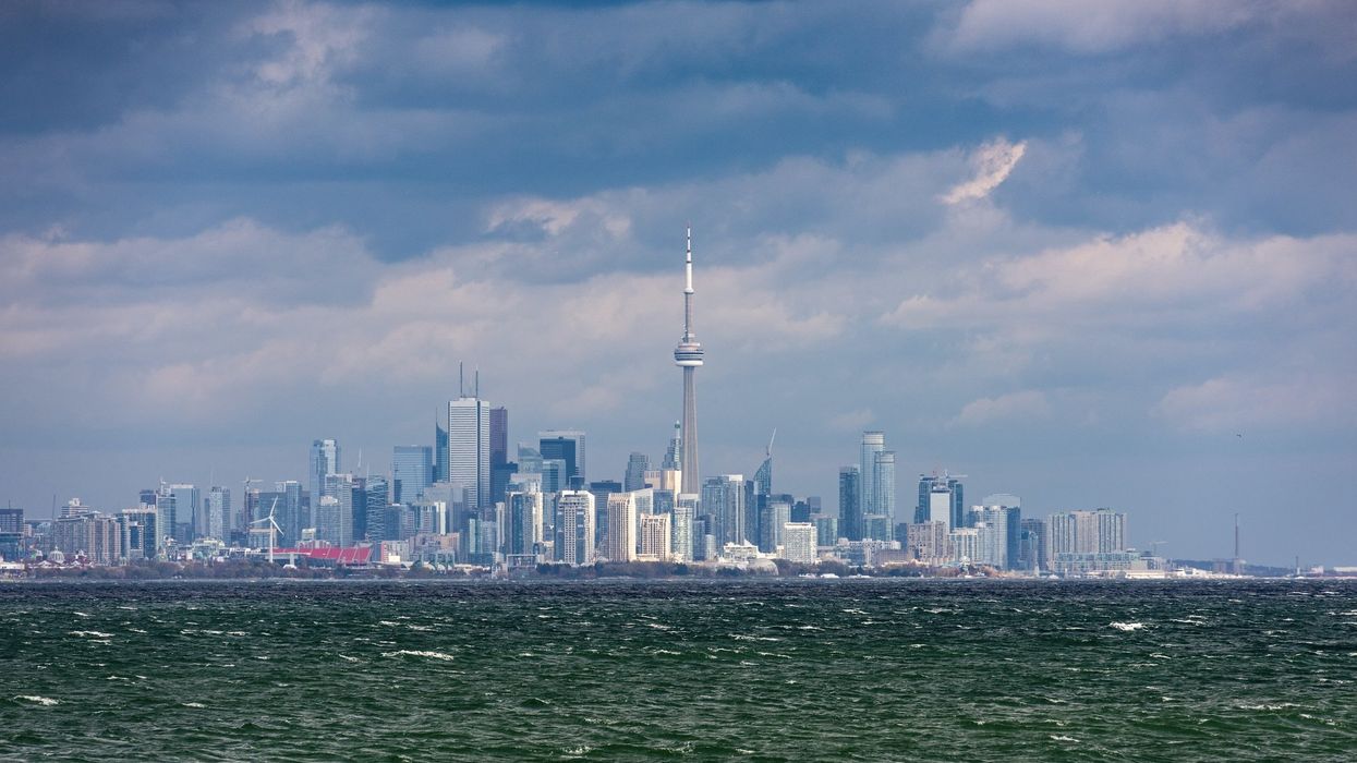 A view of the Toronto skyline from Lake Ontario during stormy weather with cloudy sky.