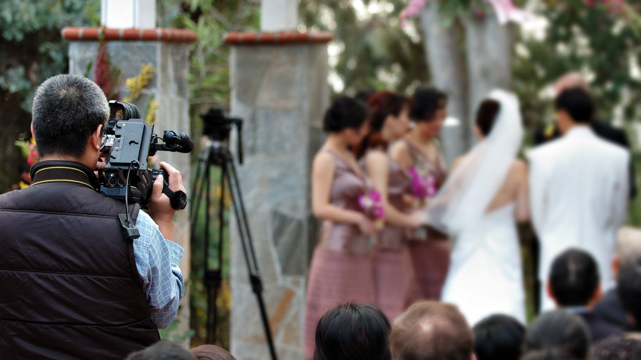 A wedding being captured by a videographer.