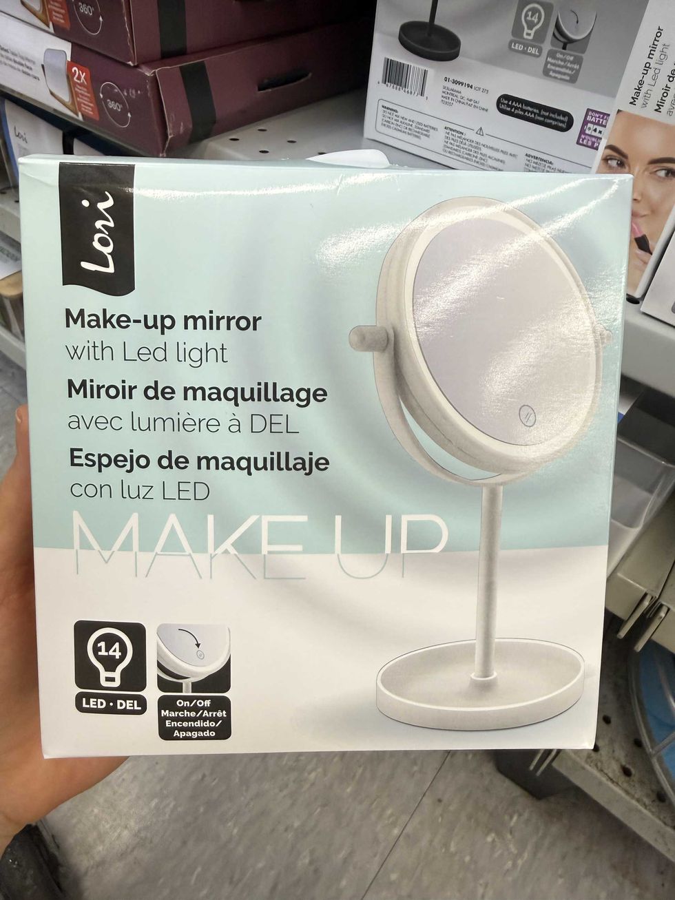 A white and light blue box with a make-up mirror with LED light.