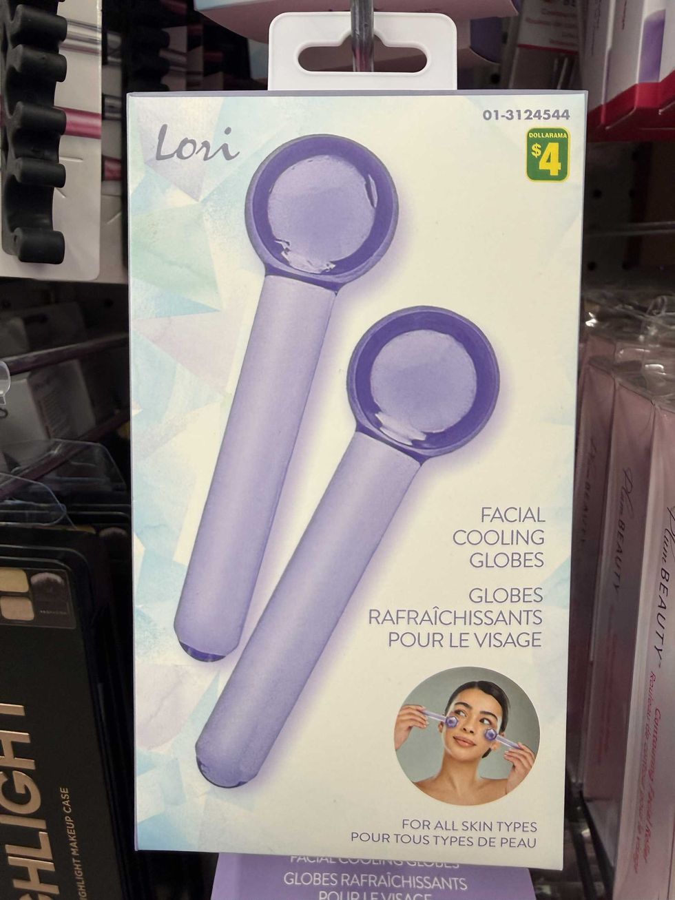 A white and purple box with two sticks on the front a woman using them on her face with the text facial cooling globes.