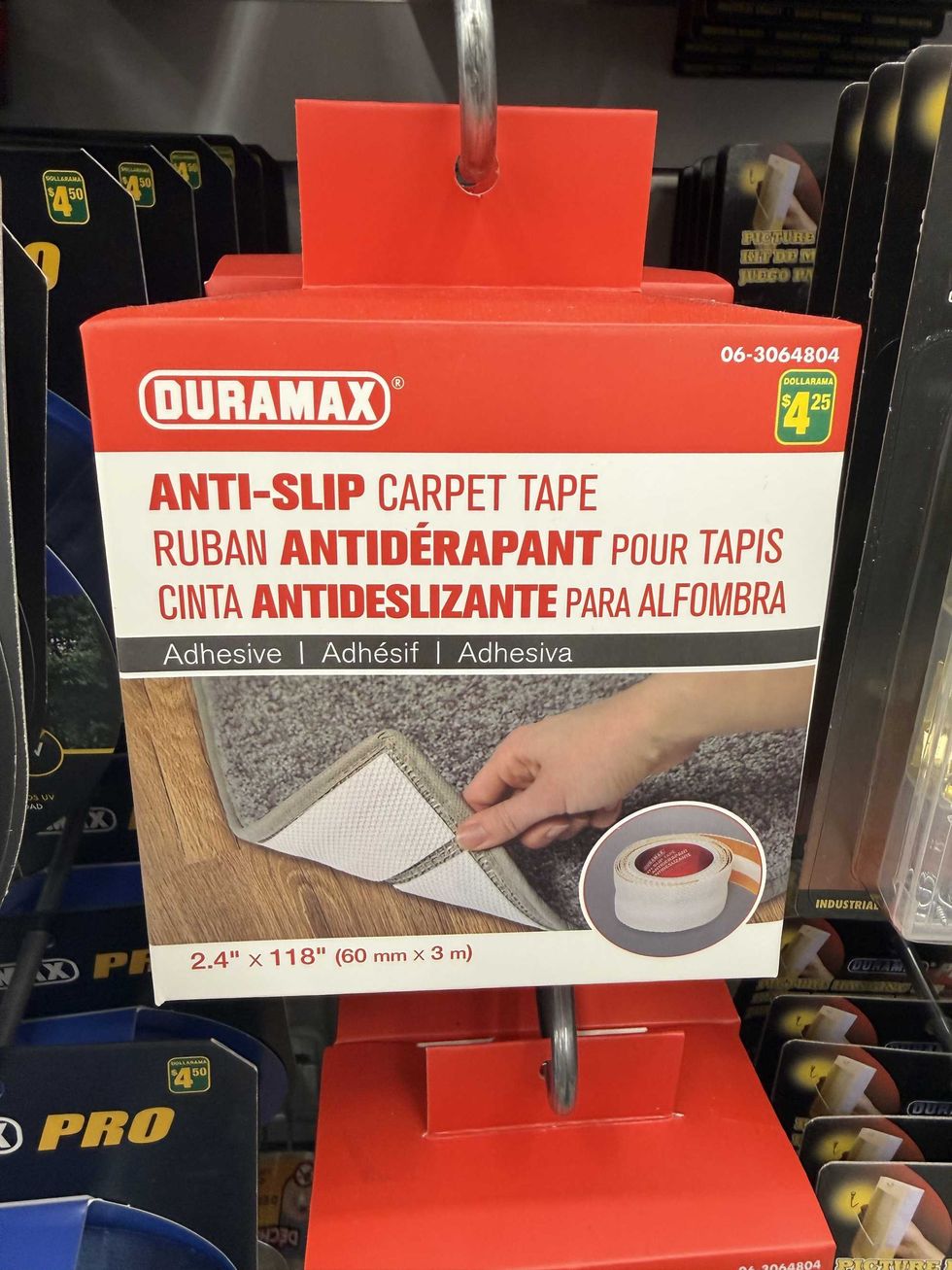 A white and red box with a picture of tape on a carpet and a label reading anti-slip carpet tape.
