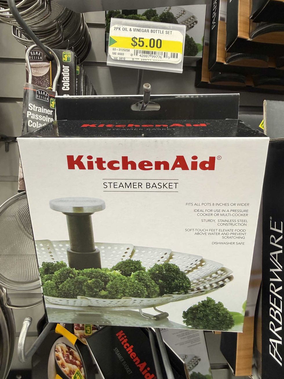 A white box with a photo of a steamer basket with broccoli sitting on it and a label that reads KitchenAid steamer basket.