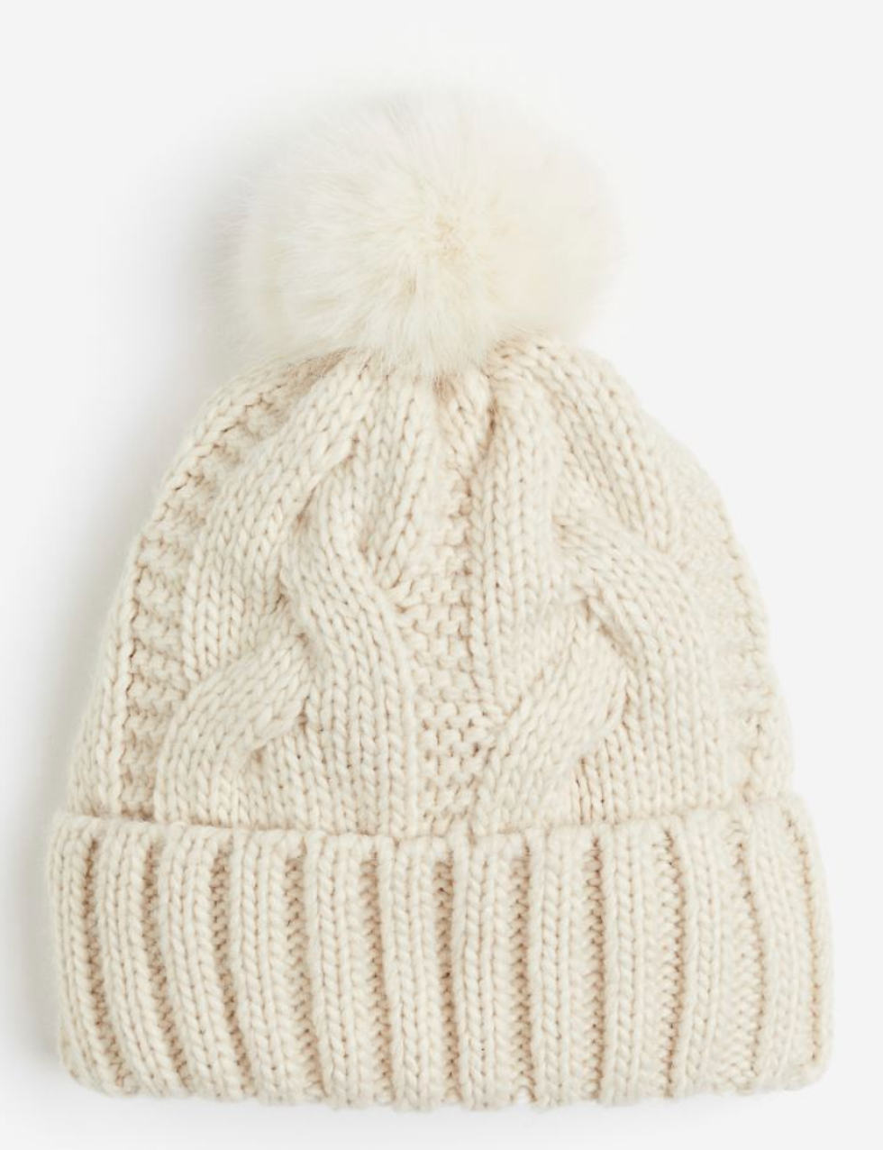 A white cable-knit pompom hat.