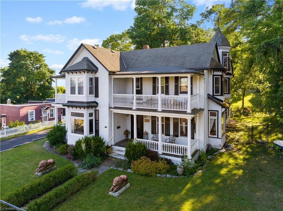 A white house with upper level porches.