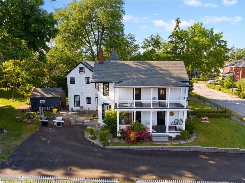 A white house with upper level porches.