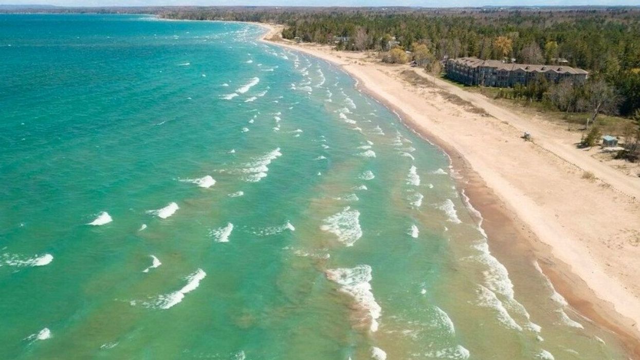 A white sandy beach with blue water.