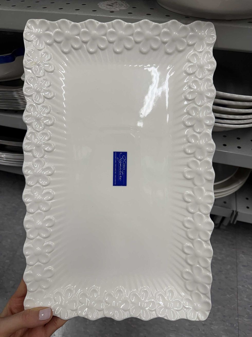 A white serving platter with flowers along the edges.