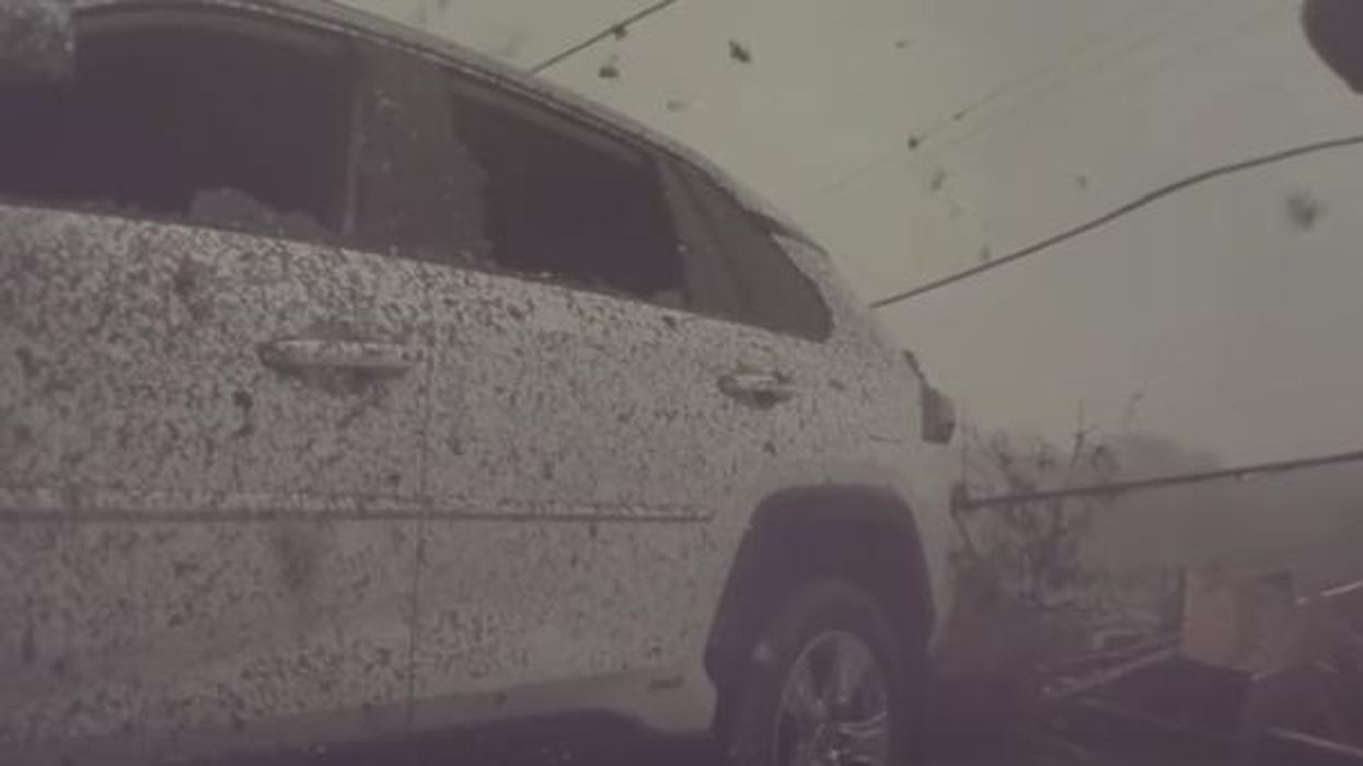 A white SUV being hit by the tornado.