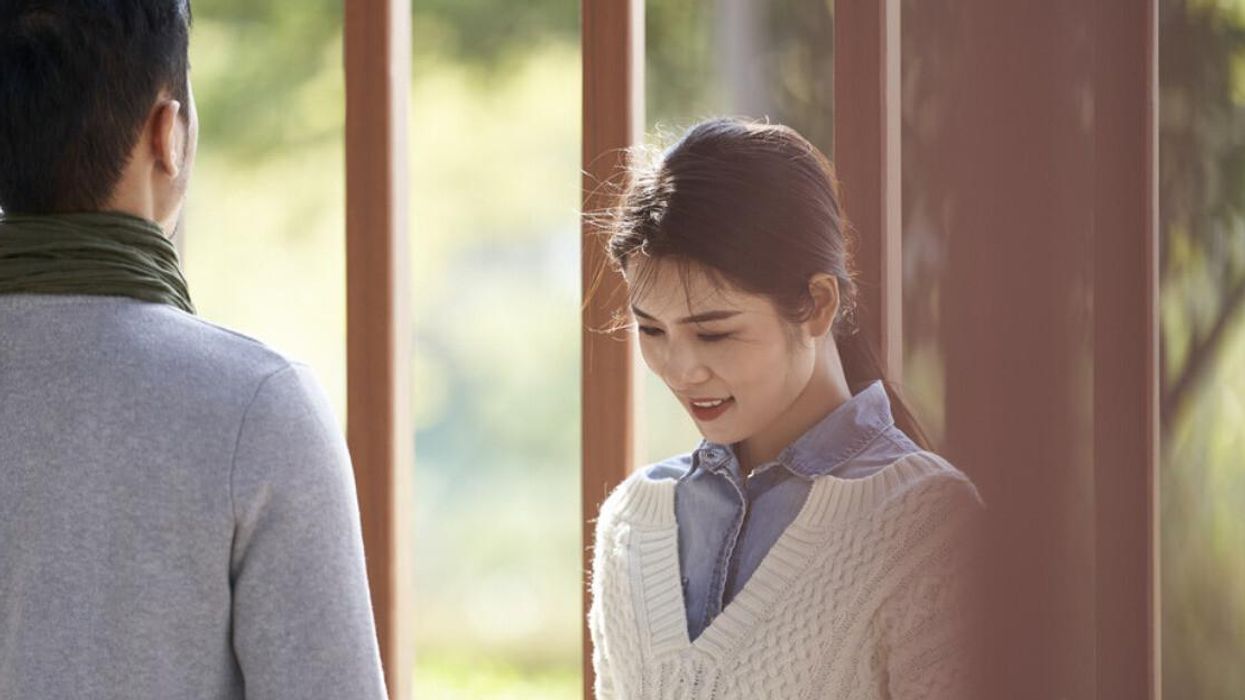 A woman and a man talking at a park.