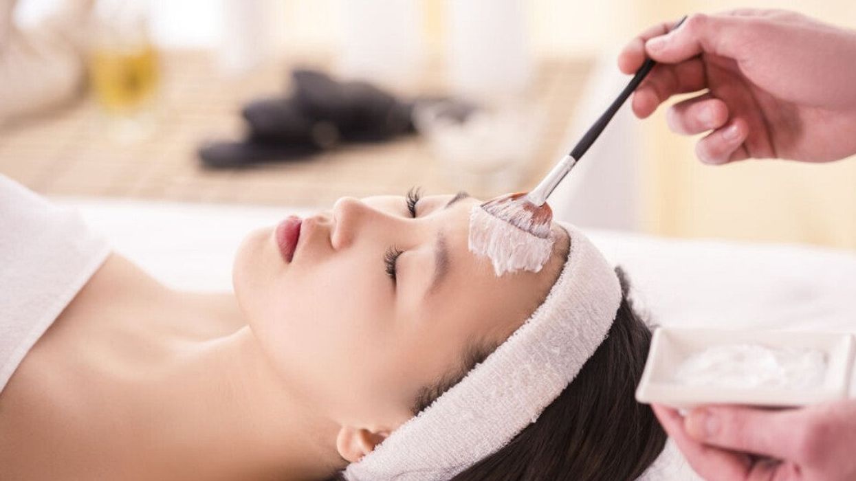 A woman getting a facial at a spa.
