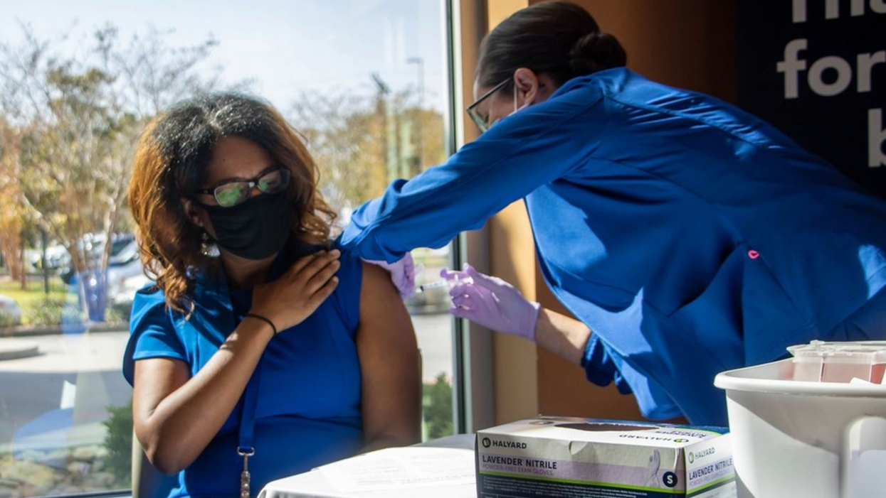 A woman getting a vaccine.