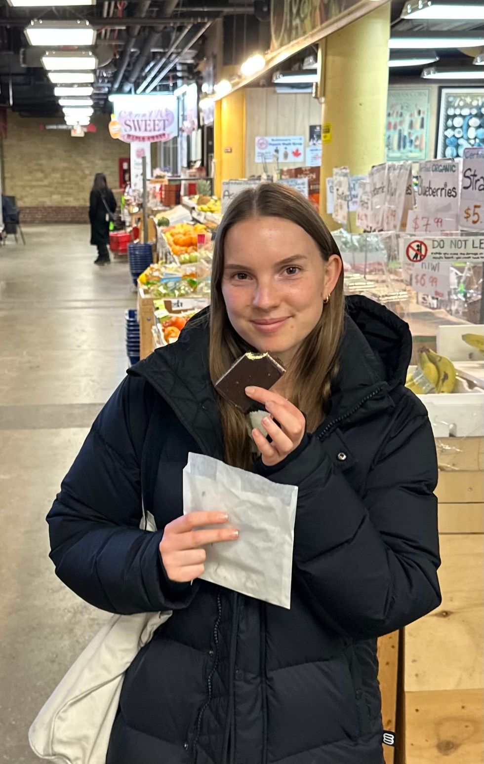 A woman holding a Nanaimo bar.