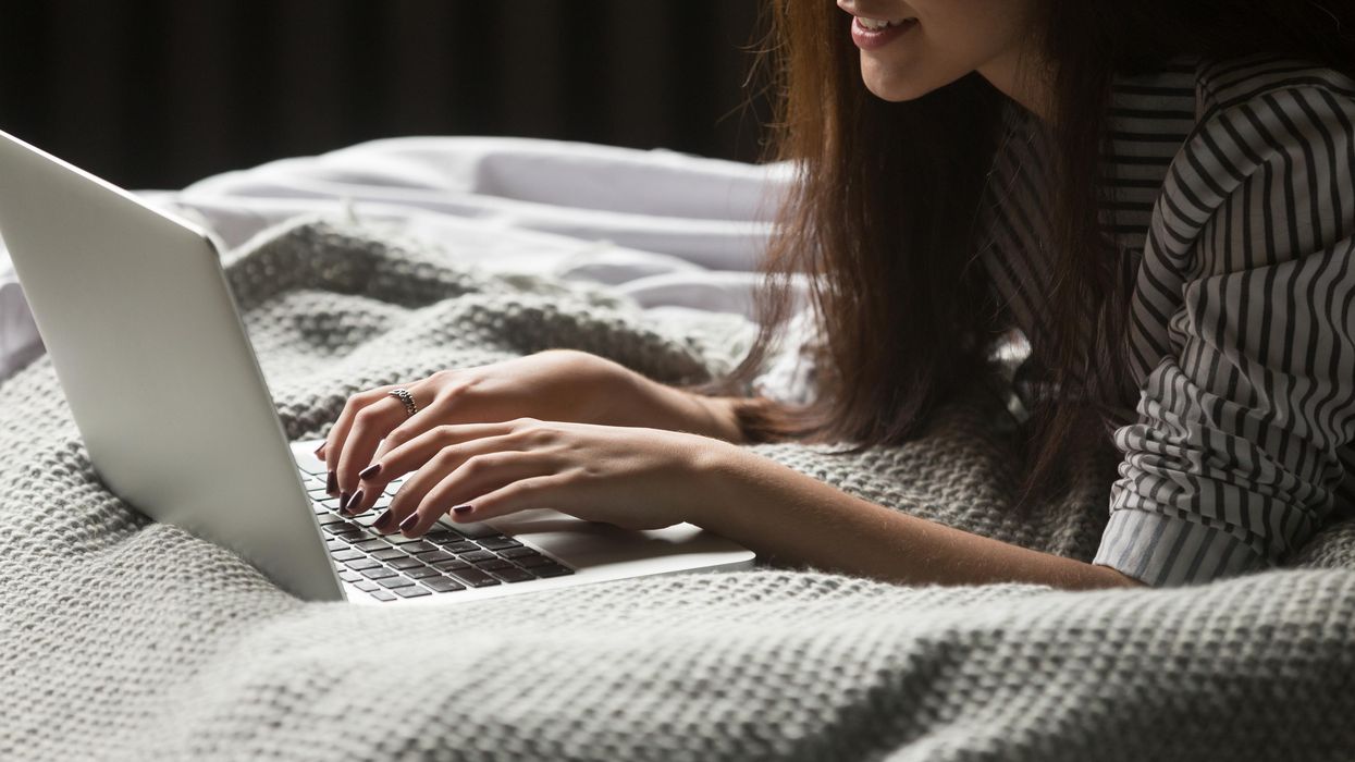 A woman in bed on her laptop.