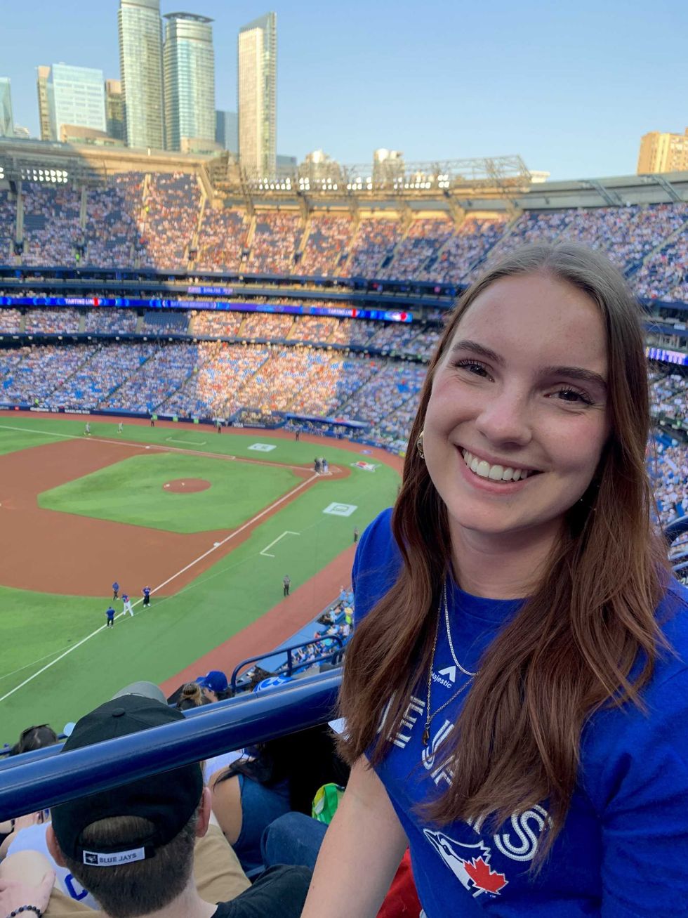 A woman in the stands at a baseball match.