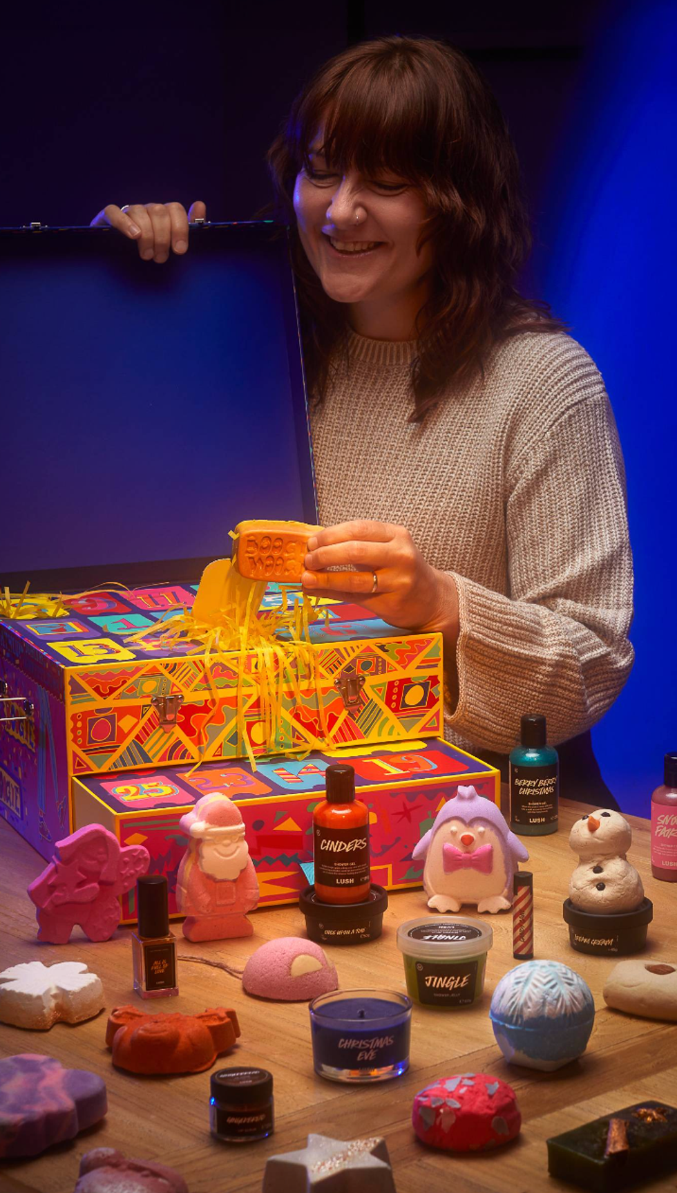 A woman looking at the Lush advent calendar.