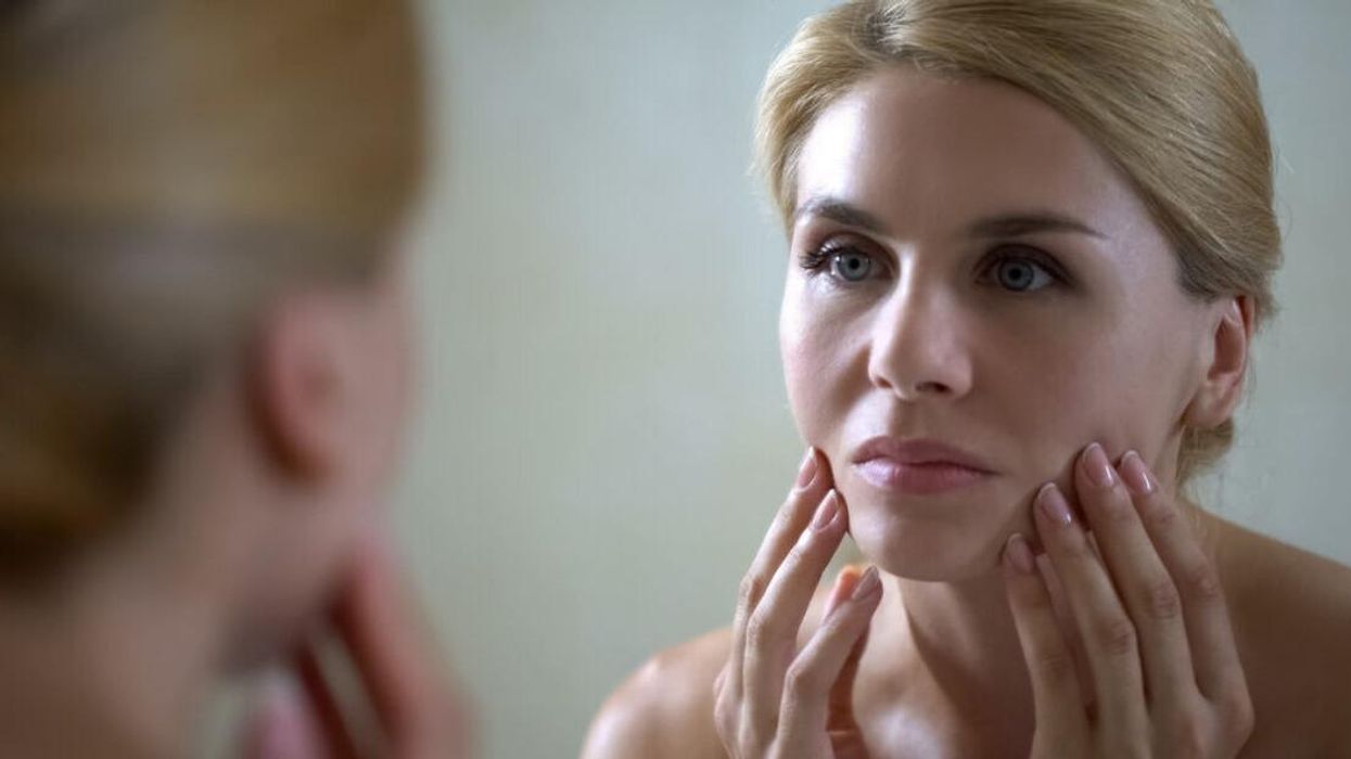 A woman looking in a mirror.