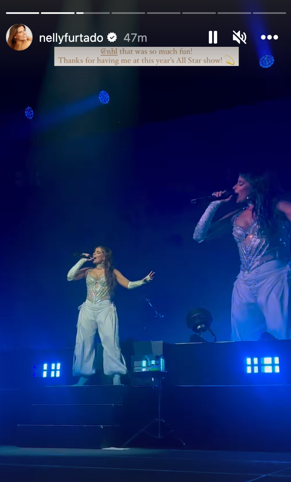 A woman singing on stage.