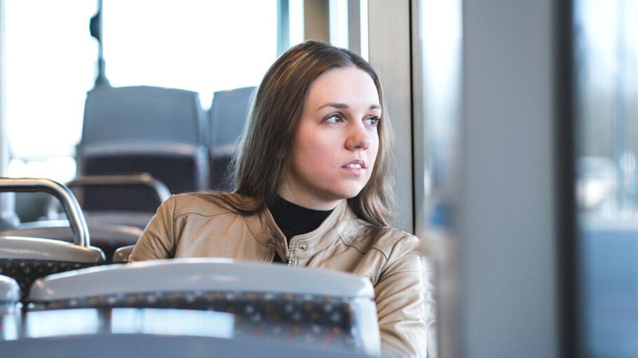 A woman sitting on a bus.