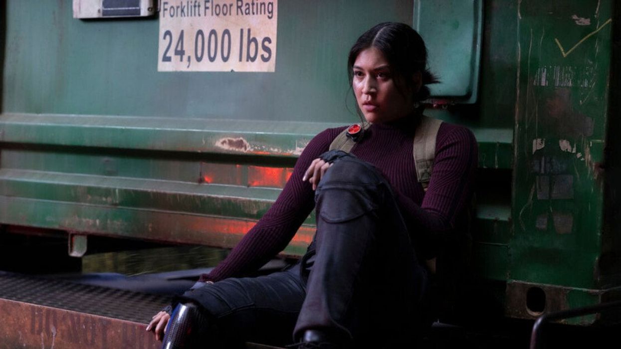 A woman sitting on a loading dock.
