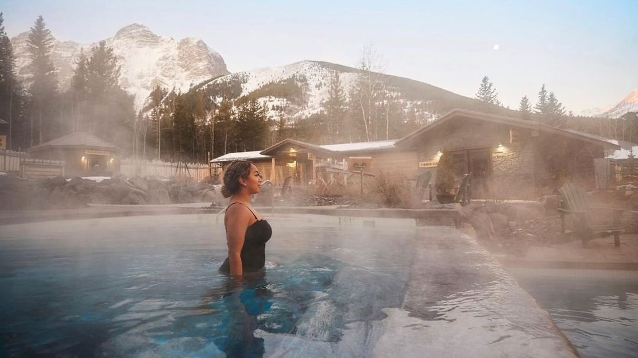 A woman soaks in a thermal pool at Kananaskis Nordic Spa in Alberta.