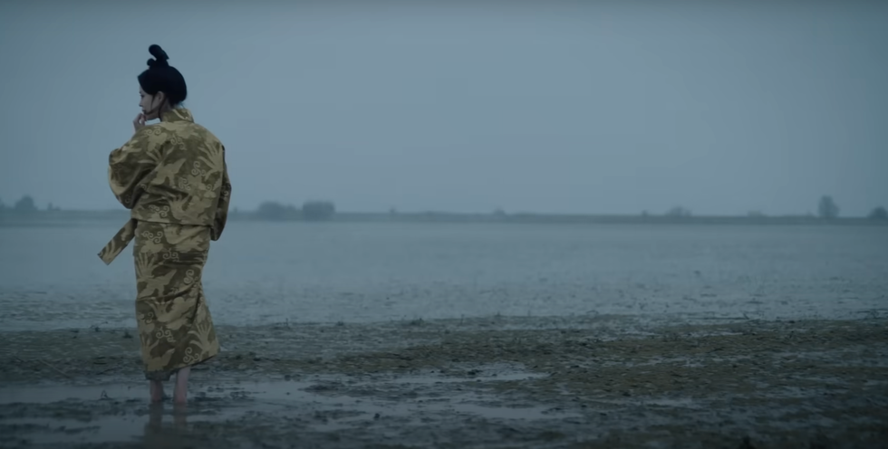 A woman standing on the beach.