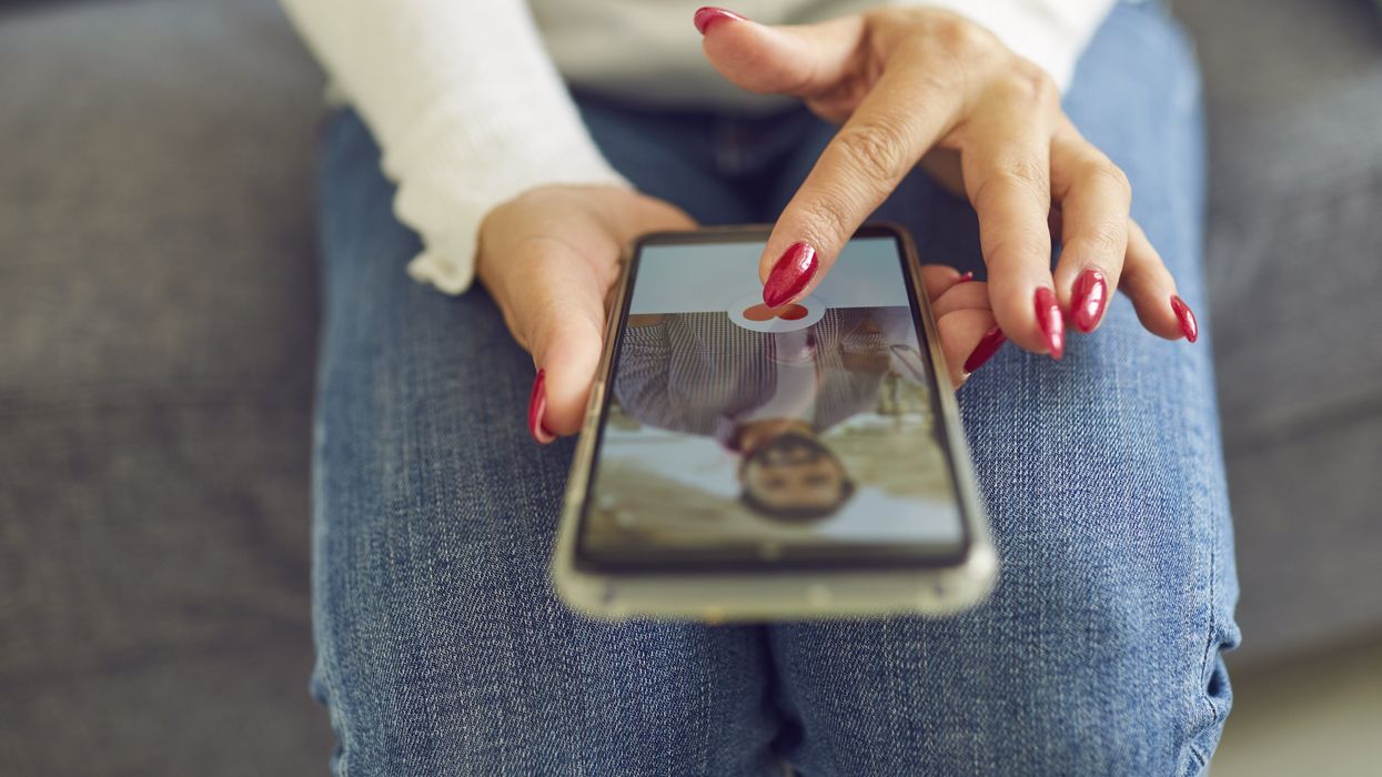 A woman swiping through a dating app.