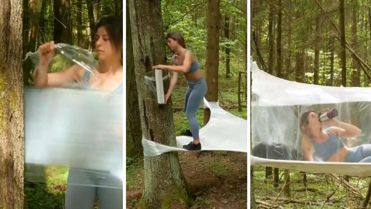 A woman uses plastic wrap to make a treehouse in the forest.