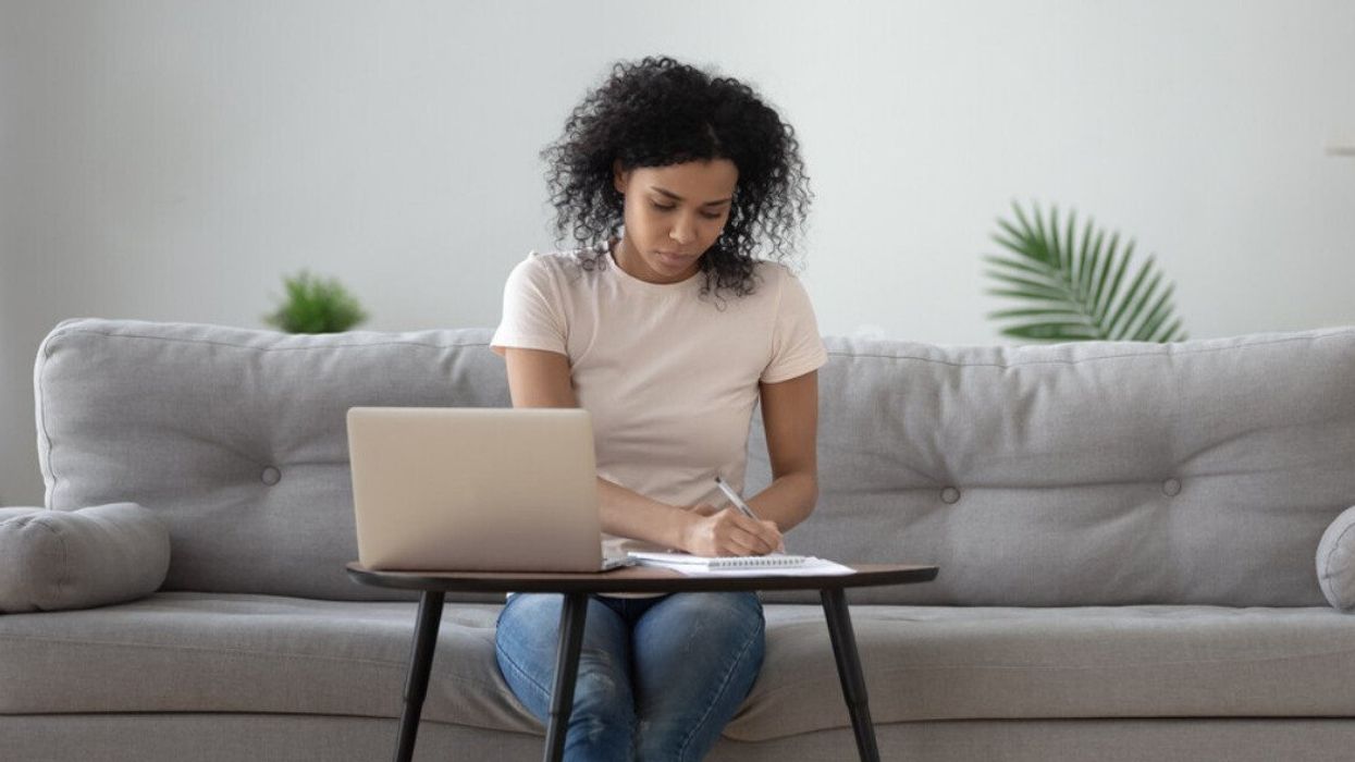 A woman working in her living room.