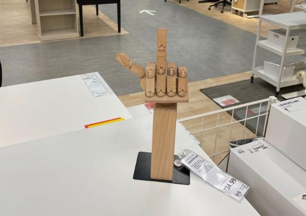 A wooden hand flipping you off.