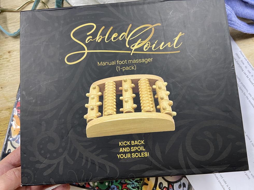 A wooden manual foot massager for sale.