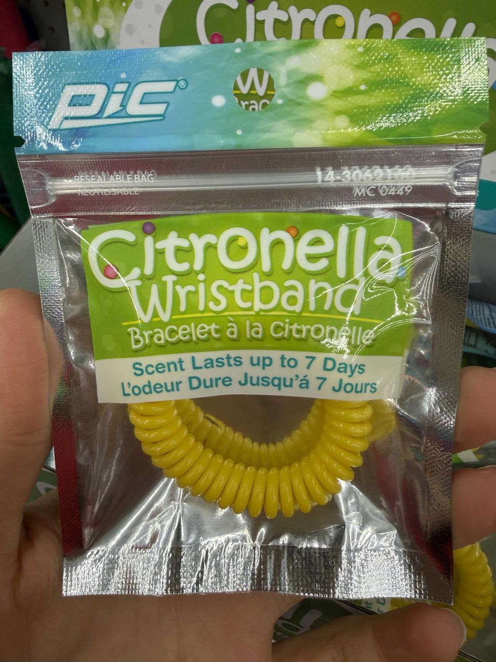 A yellow bracelet in a plastic bag that says Citronella wristband on the front.