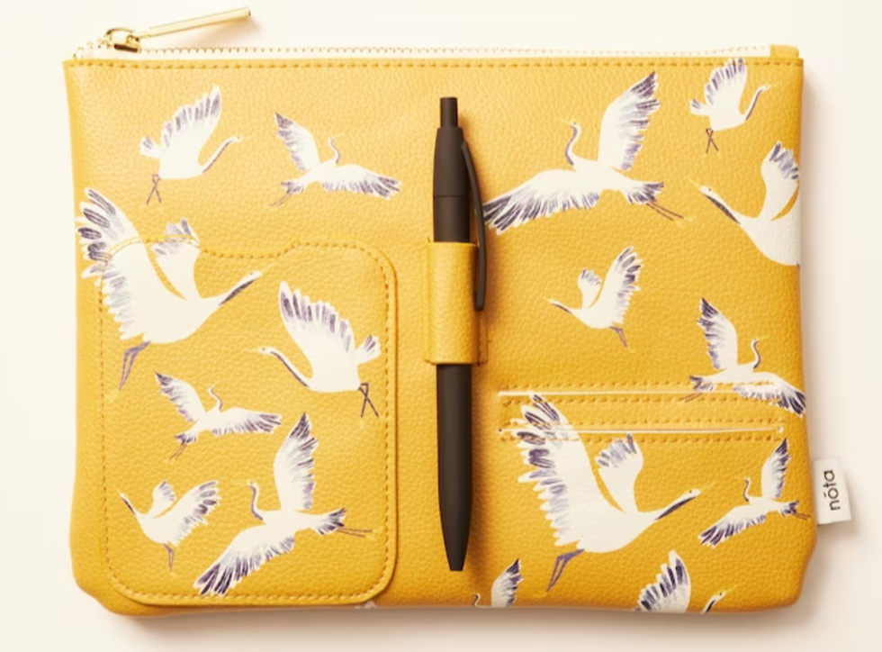 A yellow office pouch with cranes on it and a black pen.