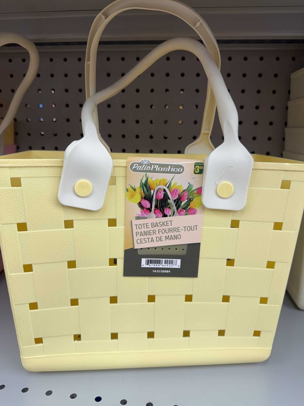 A yellow plastic tote bag on a store shelf.