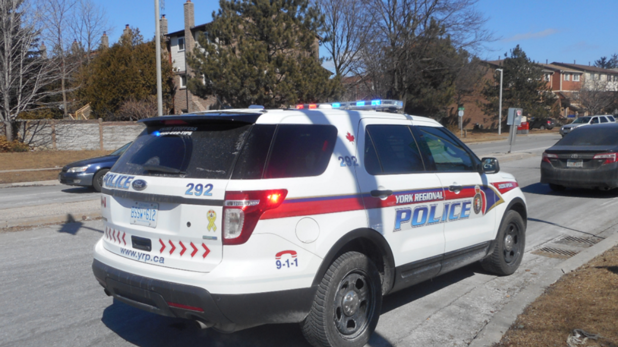 A York Regional Police car parked along the curb behind another vehicle.