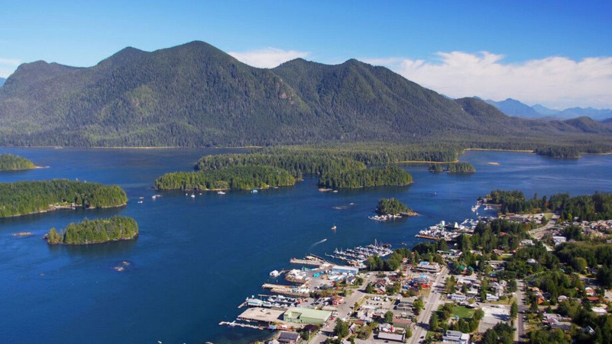 Aerial image of mountains, water, and a small town.