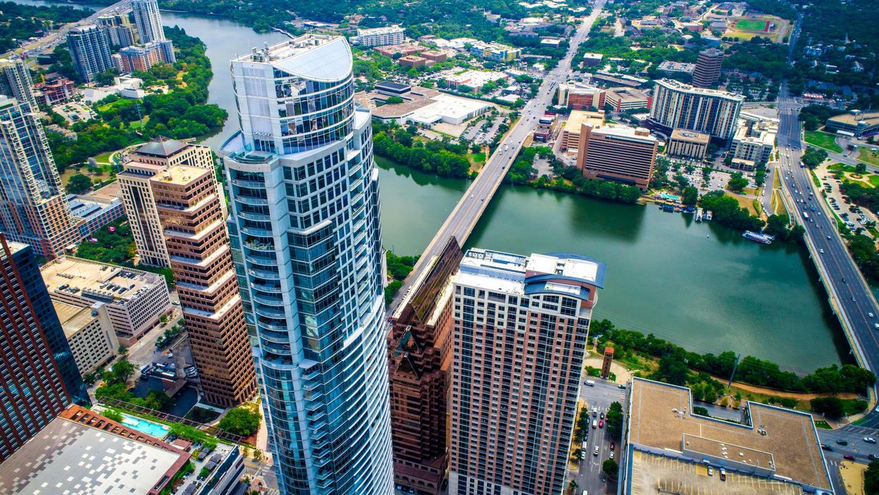 Aerial view of Austin, Texas: high-rise buildings, a body of water and a bridge.