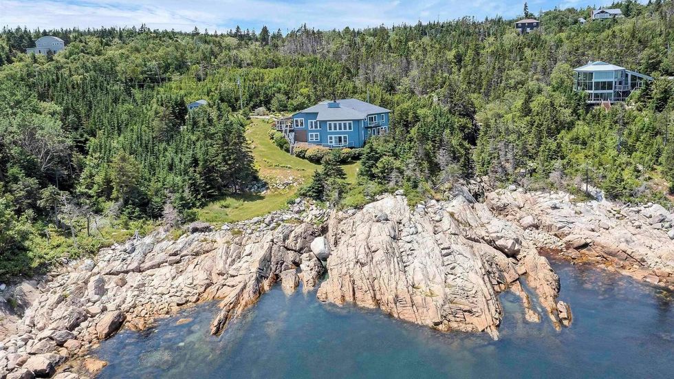 Aerial view of the house and the staggering cliffs that lead down to the ocean.