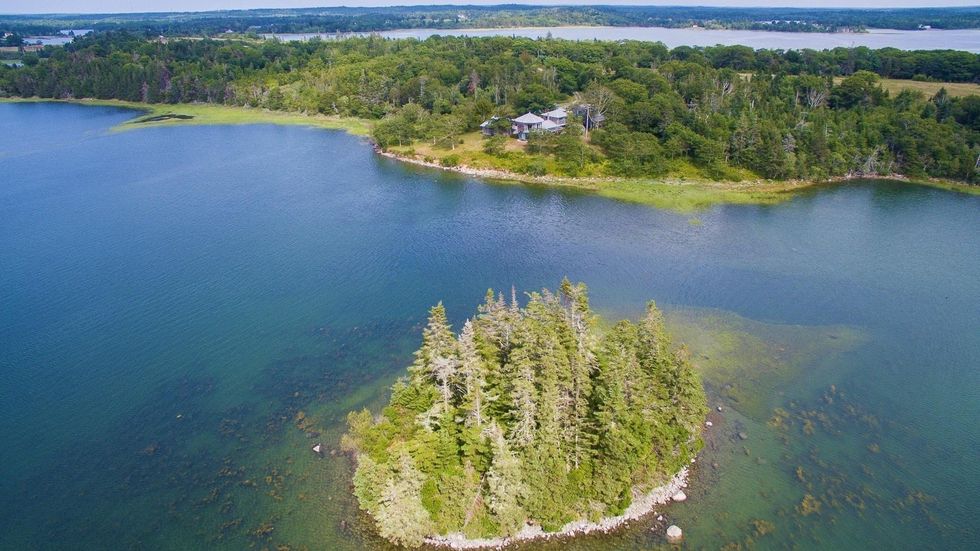 Aerial view of the house for sale and its private island.