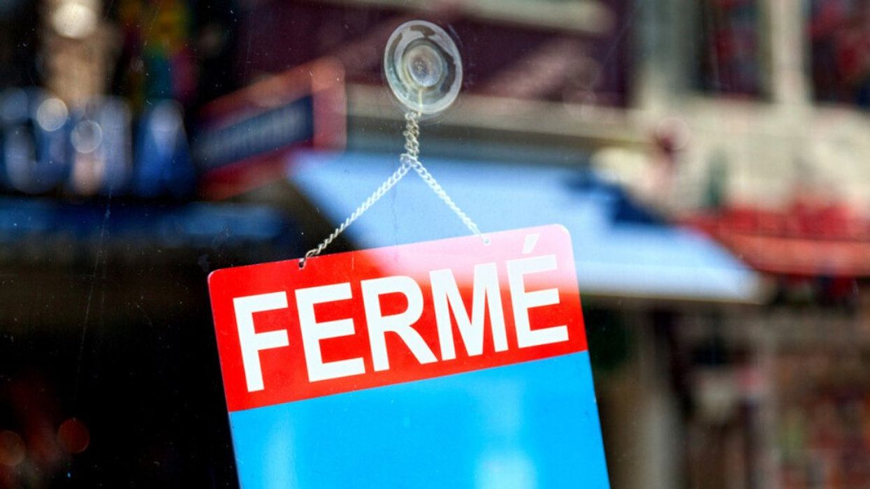 Affiche « fermé » dans la fenêtre d'un commerce.