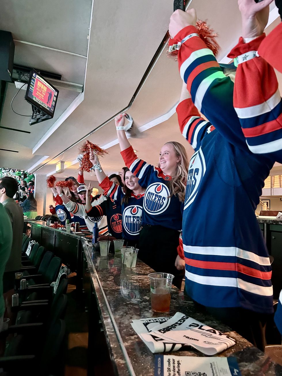 Air Canada Fan Flight winners cheering during the Oilers vs Dallas game.
