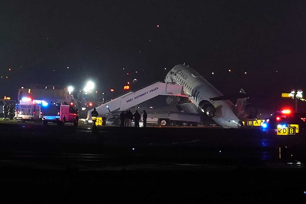 Air Canada plane crash wreckage on a runway.