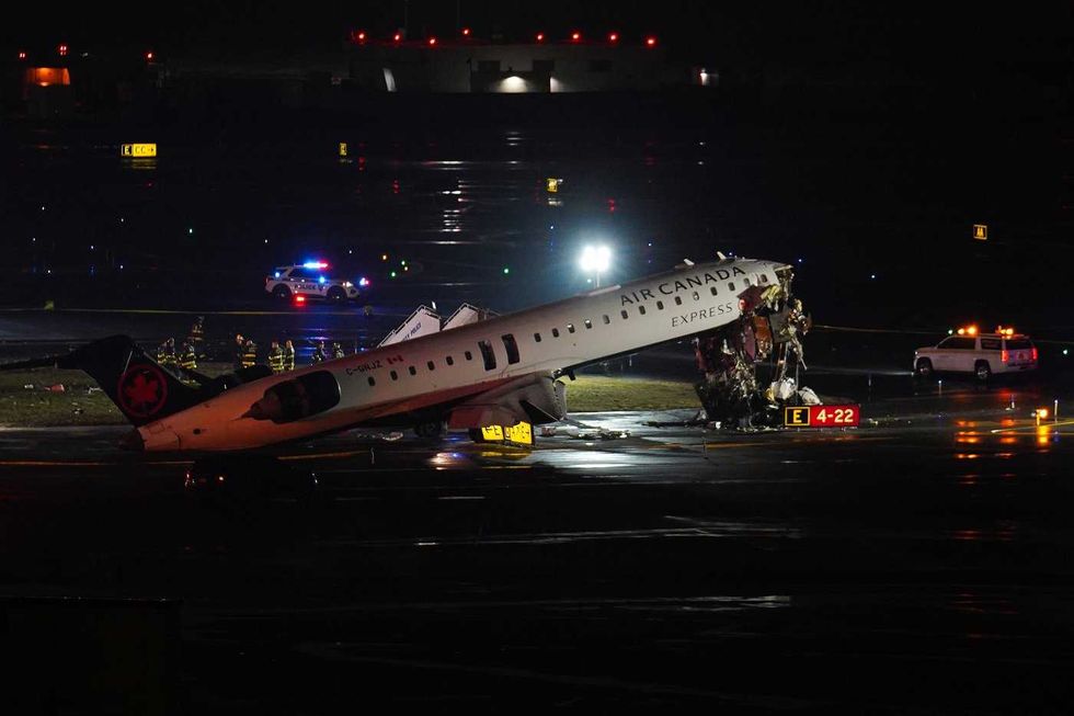 Air Canada plane crash wreckage on a runway.