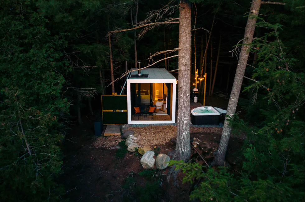Airbnb in a forest with a hot tub.